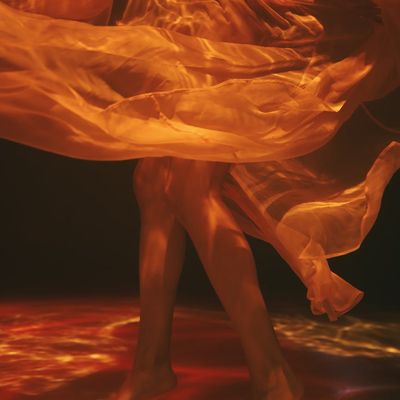 Blurred silhouette of a person performing a smooth yoga flow