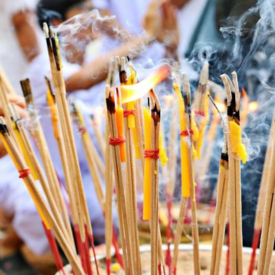 Incense sticks burning in a dark peaceful room